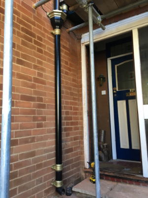 Black cast iron downpipe with rainwater hopper head